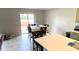 Bright dining area features sliding glass doors to the deck and connects to the open concept kitchen with tile flooring at 39567 Dawson Chase Dr, Zephyrhills, FL 33540
