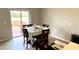 Dining room features a table with seating for four and a sliding door to the backyard at 39567 Dawson Chase Dr, Zephyrhills, FL 33540