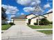 Charming single-story home features a two-car garage, manicured lawn and mature landscaping at 39567 Dawson Chase Dr, Zephyrhills, FL 33540