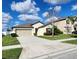 Charming home with a well-manicured lawn, mature landscaping, and a two-car garage at 39567 Dawson Chase Dr, Zephyrhills, FL 33540