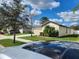 Exterior view of a home with a well-maintained lawn and palm trees at 39567 Dawson Chase Dr, Zephyrhills, FL 33540