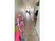 Long hallway with tile flooring leading into the living room at 39567 Dawson Chase Dr, Zephyrhills, FL 33540