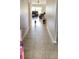 Long hallway with tile flooring leading into the living room at 39567 Dawson Chase Dr, Zephyrhills, FL 33540