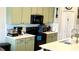Kitchen features stainless steel appliances, green cabinets, ample counter space, and a modern design at 39567 Dawson Chase Dr, Zephyrhills, FL 33540