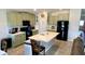 Kitchen with island, light green cabinets, and black appliances at 39567 Dawson Chase Dr, Zephyrhills, FL 33540