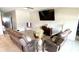 Living room features tile flooring, comfortable seating and a mounted television at 39567 Dawson Chase Dr, Zephyrhills, FL 33540