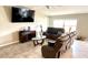 Bright living room featuring tile floors, large tv, and plenty of comfortable seating at 39567 Dawson Chase Dr, Zephyrhills, FL 33540
