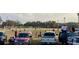 Community soccer field with parked cars, tents, and people watching the game at 39567 Dawson Chase Dr, Zephyrhills, FL 33540