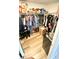 A walk-in closet with laminate floors, shoe racks, metal shelving, and black storage at 39567 Dawson Chase Dr, Zephyrhills, FL 33540