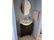 Small bathroom with dark vanity and oval mirror at 2232 Gifford St, Port Charlotte, FL 33952