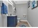 Modern bathroom with blue vanity and hexagon shelves at 25393 Durango Ct, Punta Gorda, FL 33955