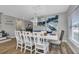 Bright dining room featuring a white table, chairs, and modern light fixture at 25393 Durango Ct, Punta Gorda, FL 33955