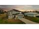 Two-story home with gray and blue exterior, landscaped yard, and attached garage at 25393 Durango Ct, Punta Gorda, FL 33955