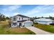 Two-story house with light-colored siding, gray roof, and a landscaped front yard at 25393 Durango Ct, Punta Gorda, FL 33955