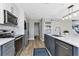 Modern kitchen with gray cabinets, white upper cabinets, and an island at 25393 Durango Ct, Punta Gorda, FL 33955
