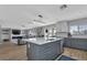 Open concept kitchen with gray cabinets, white countertops, and island seating at 25393 Durango Ct, Punta Gorda, FL 33955