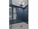 Modern shower with dark blue tile and built-in niches at 25393 Durango Ct, Punta Gorda, FL 33955