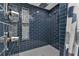 Modern shower with dark blue tile and built-in niches at 25393 Durango Ct, Punta Gorda, FL 33955