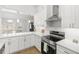 Modern white kitchen with stainless steel appliances and quartz countertops at 815 Bluegrass Ln, Brandon, FL 33510