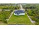 Aerial view of a modern home with a large, well-maintained backyard at 13438 Mcintosh Ave, Port Charlotte, FL 33981