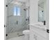 White tile shower, toilet, and vanity at 13438 Mcintosh Ave, Port Charlotte, FL 33981