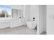 Bright bathroom featuring a sleek soaking tub, marble floors, and a vanity with drawers at 13438 Mcintosh Ave, Port Charlotte, FL 33981