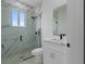 White tile shower, toilet, and vanity at 13438 Mcintosh Ave, Port Charlotte, FL 33981