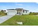 Beautiful modern home with a well-manicured lawn and a neutral-toned exterior at 13438 Mcintosh Ave, Port Charlotte, FL 33981