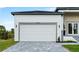 A well-manicured front lawn and a white garage door at 13438 Mcintosh Ave, Port Charlotte, FL 33981