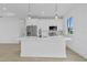 Modern kitchen island with quartz countertops, stainless appliances, and stylish pendant lighting at 13438 Mcintosh Ave, Port Charlotte, FL 33981