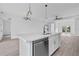 A modern kitchen island features a double sink, stainless steel dishwasher, and plenty of space at 13438 Mcintosh Ave, Port Charlotte, FL 33981