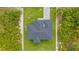 Birds eye view of roof and layout of modern home with surrounding vegetation at 13438 Mcintosh Ave, Port Charlotte, FL 33981