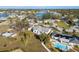 Aerial shot of a bright, modern home with a backyard pool in a lakeside community with lush greenery and waterways at 105 12Th Sw St, Ruskin, FL 33570