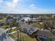 Aerial shot of a cozy waterfront home nestled in a vibrant community with canals, docks, and swaying palm trees at 105 12Th Sw St, Ruskin, FL 33570