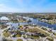 Expansive aerial view showcasing waterfront homes on canals and a glimpse of the ocean horizon at 105 12Th Sw St, Ruskin, FL 33570