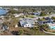 Aerial view of a bright home with a well-manicured lawn, landscaping, and a modern pool, nestled in a waterfront community at 105 12Th Sw St, Ruskin, FL 33570