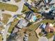 An aerial view of a neighborhood with houses, lawns, roads, and docks near the water, showcasing the community layout at 105 12Th Sw St, Ruskin, FL 33570