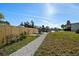 Bench in the backyard with a pathway leading to a dock with a view of the canal at 105 12Th Sw St, Ruskin, FL 33570