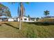 A backyard with a lush lawn, a screen porch, and multiple storage sheds provides great outdoor living at 105 12Th Sw St, Ruskin, FL 33570