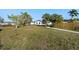 Expansive backyard featuring a well-maintained lawn and mature trees, perfect for outdoor activities and relaxation at 105 12Th Sw St, Ruskin, FL 33570