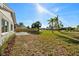 Backyard with a newly installed fence and multiple palm trees provides serene outdoor living at 105 12Th Sw St, Ruskin, FL 33570