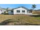 A white home features a screened in porch and a backyard with green grass at 105 12Th Sw St, Ruskin, FL 33570