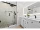 Modern bathroom with dual vanity, backlit mirror and walk-in shower with beautiful tile surround at 105 12Th Sw St, Ruskin, FL 33570