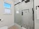 Beautiful bathroom featuring a glass shower with marble walls and grey tile floors at 105 12Th Sw St, Ruskin, FL 33570