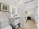 Well-lit bathroom featuring a modern sink and a view into the primary bedroom at 105 12Th Sw St, Ruskin, FL 33570