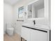 Modern bathroom with sleek vanity, illuminated mirror, and contemporary fixtures at 105 12Th Sw St, Ruskin, FL 33570