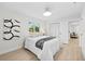 Bright bedroom with a comfortable bed and view into the living room at 105 12Th Sw St, Ruskin, FL 33570