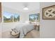 Bright bedroom with natural light, featuring neutral decor, a cozy rug, and two windows overlooking the yard at 105 12Th Sw St, Ruskin, FL 33570