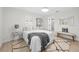 Bright bedroom with natural light, featuring a comfortable bed, a cozy rug, and simple neutral decor at 105 12Th Sw St, Ruskin, FL 33570