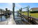 Dock area featuring boat lifts and a wooden dock with beautiful clear water at 105 12Th Sw St, Ruskin, FL 33570